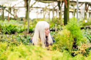 Sarah with Ferns in Greenhouse
