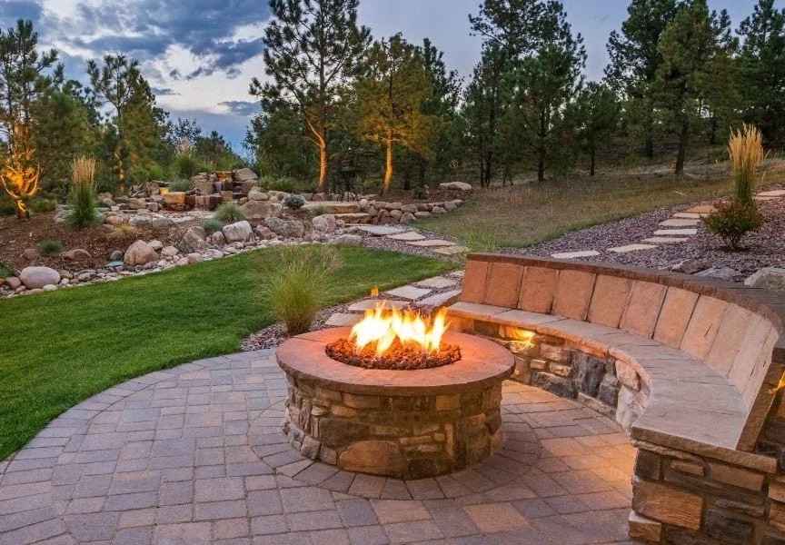 A photo of a landscaped property in California with a fire pit and patio.